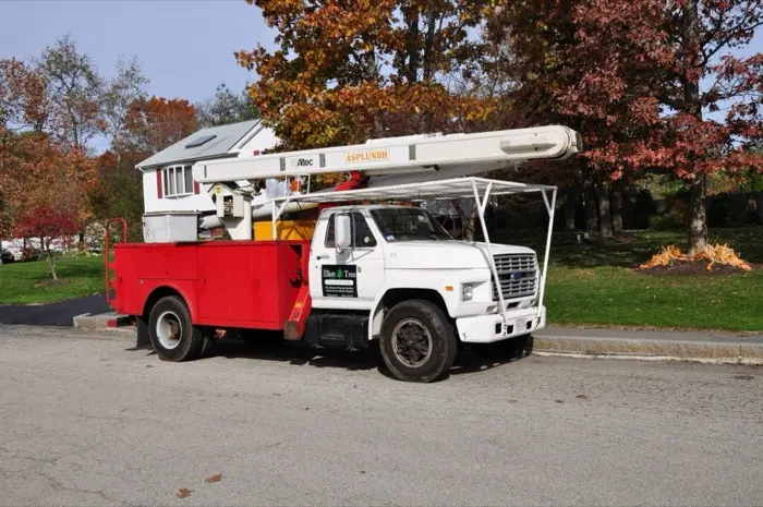 Bucket truck working among fall foliage